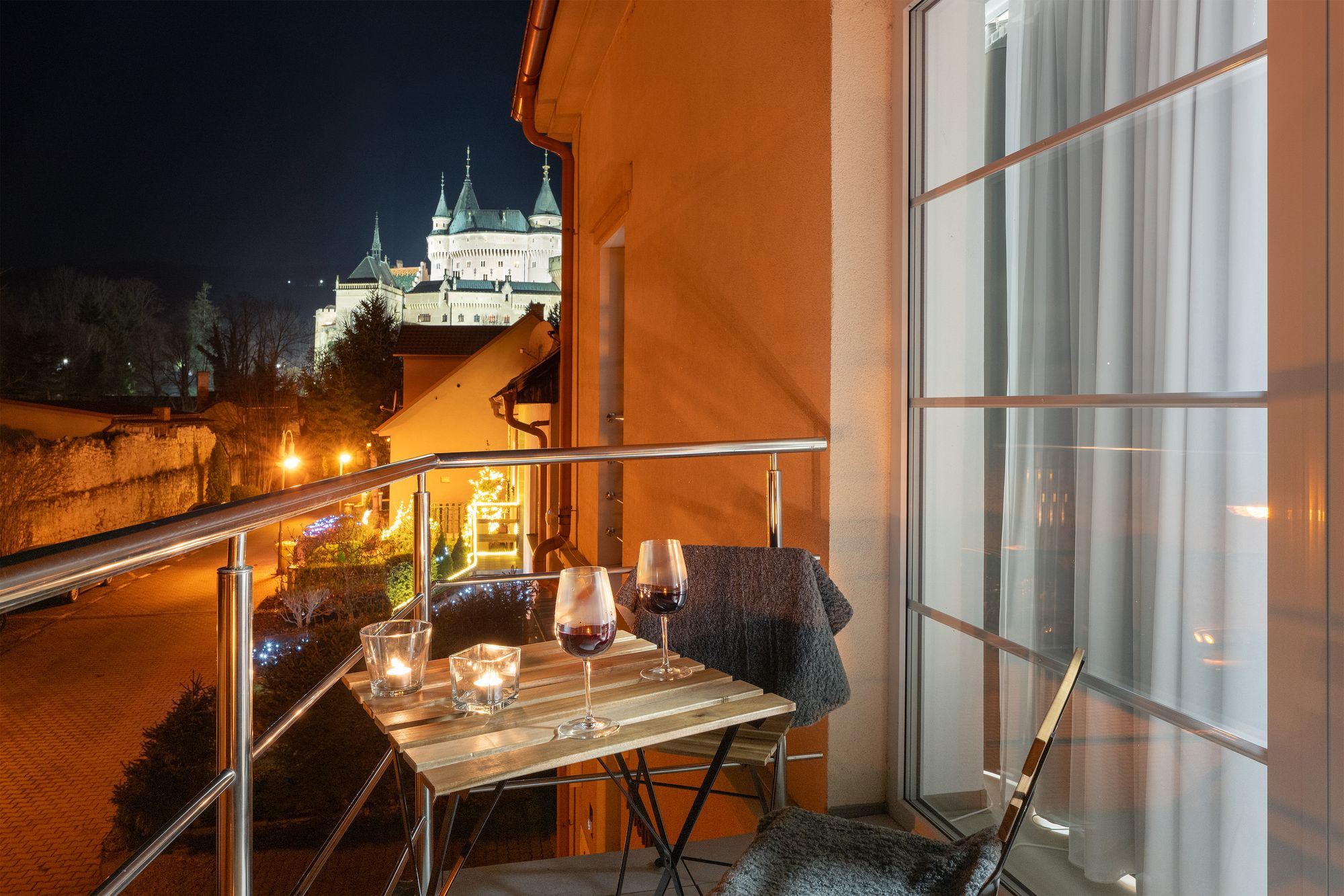 Balkón apartmánu Antré s výhľadom na osvetlený Bojnický zámok